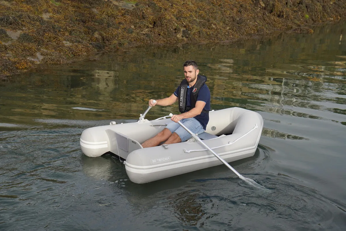 3D Tender World Travel 235: A man rowing a rubber dinghy on the water