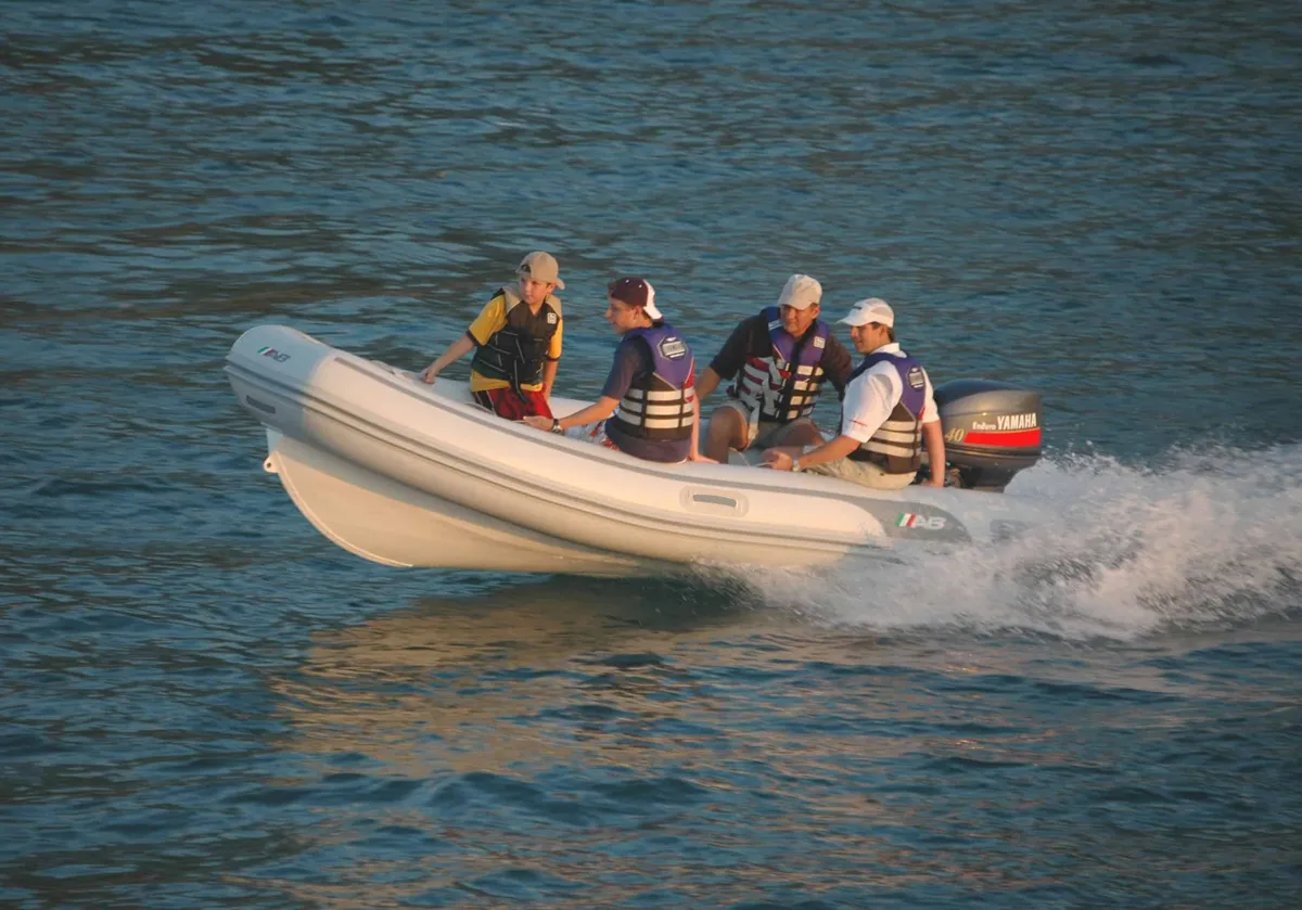 AB Inflatables Lammina 14 AL: A rubber dinghy with people on board is travelling at speed