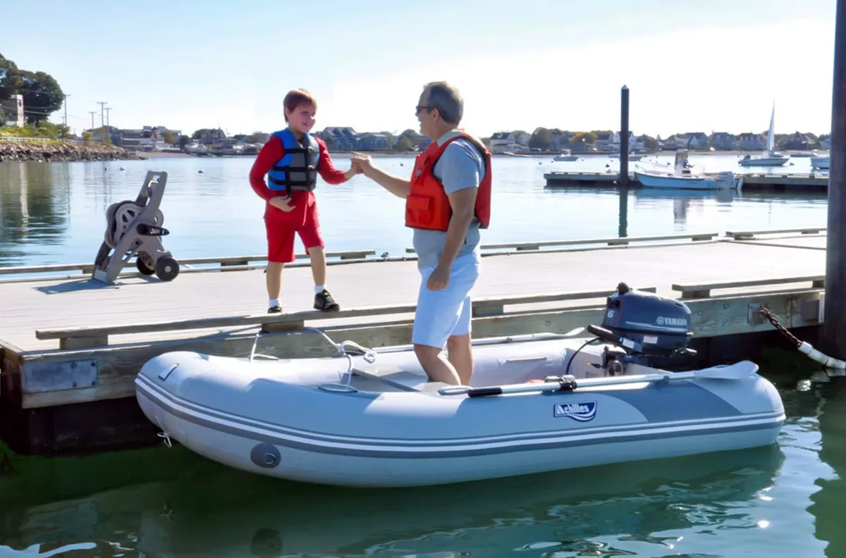Achilles LSI-360E: Man and boy by a rubber dinghy