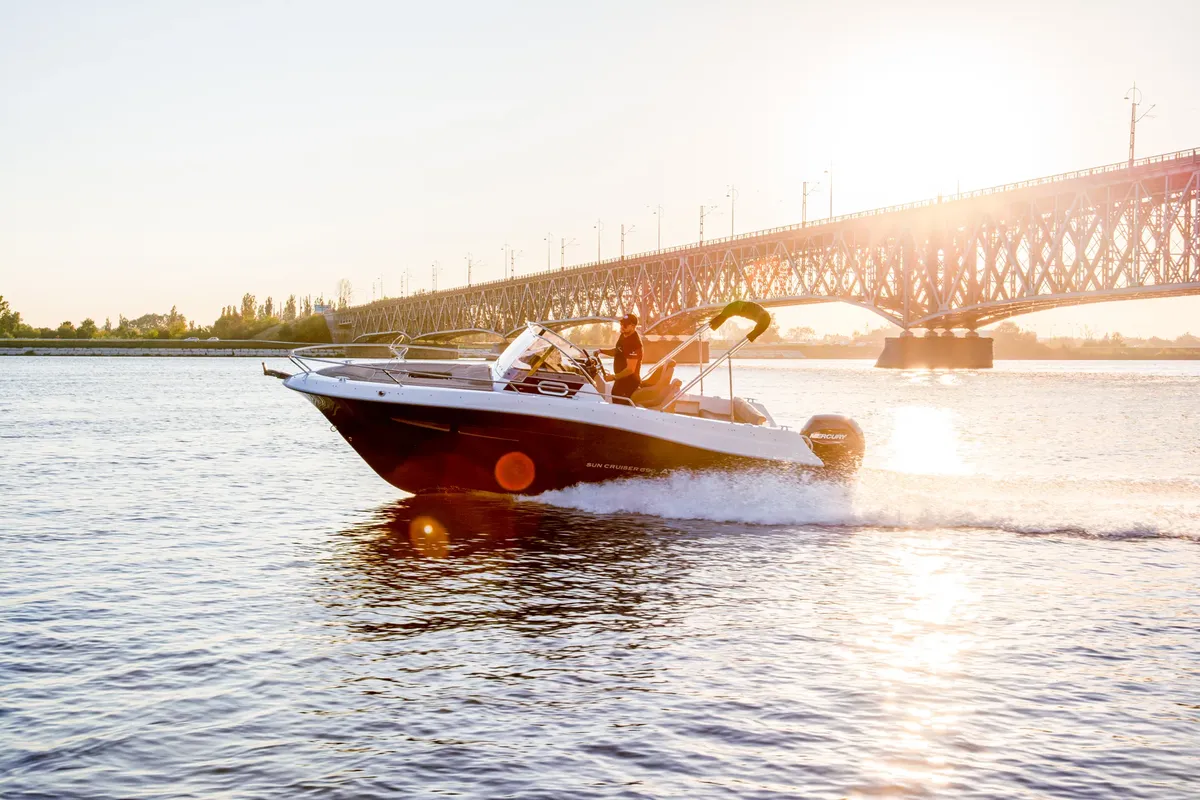 Atlantic Marine Sun Cruiser 690: Boat cruising under a bridge