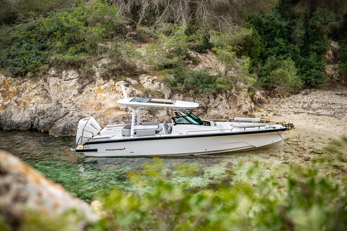 Axopar 29 Sun Top: Boat moored off a rocky coast