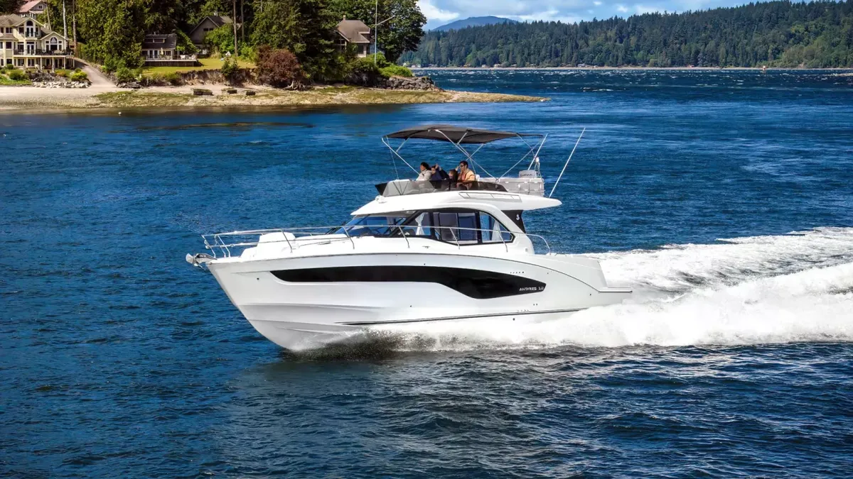 Beneteau Antares 12 Fly: White boat cruising across the water