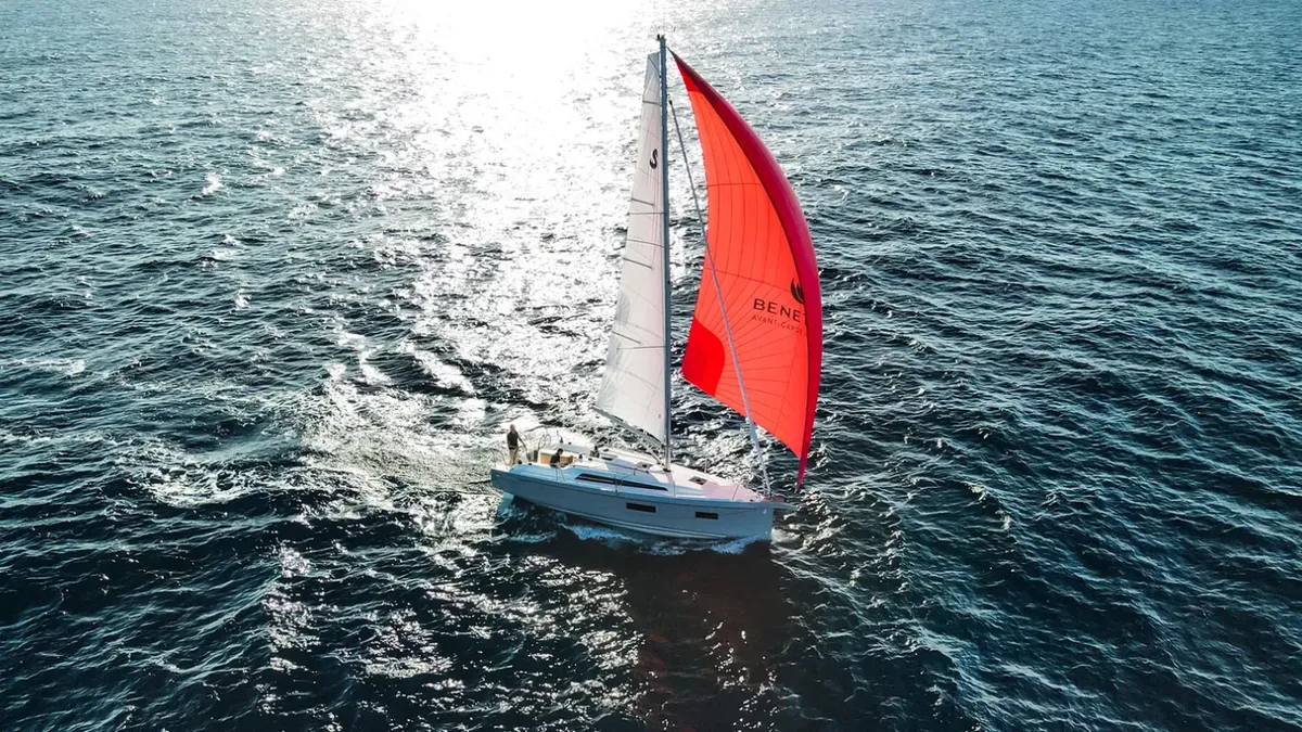 Beneteau Oceanis 34.1: Sailing boat with a red spinnaker at sea