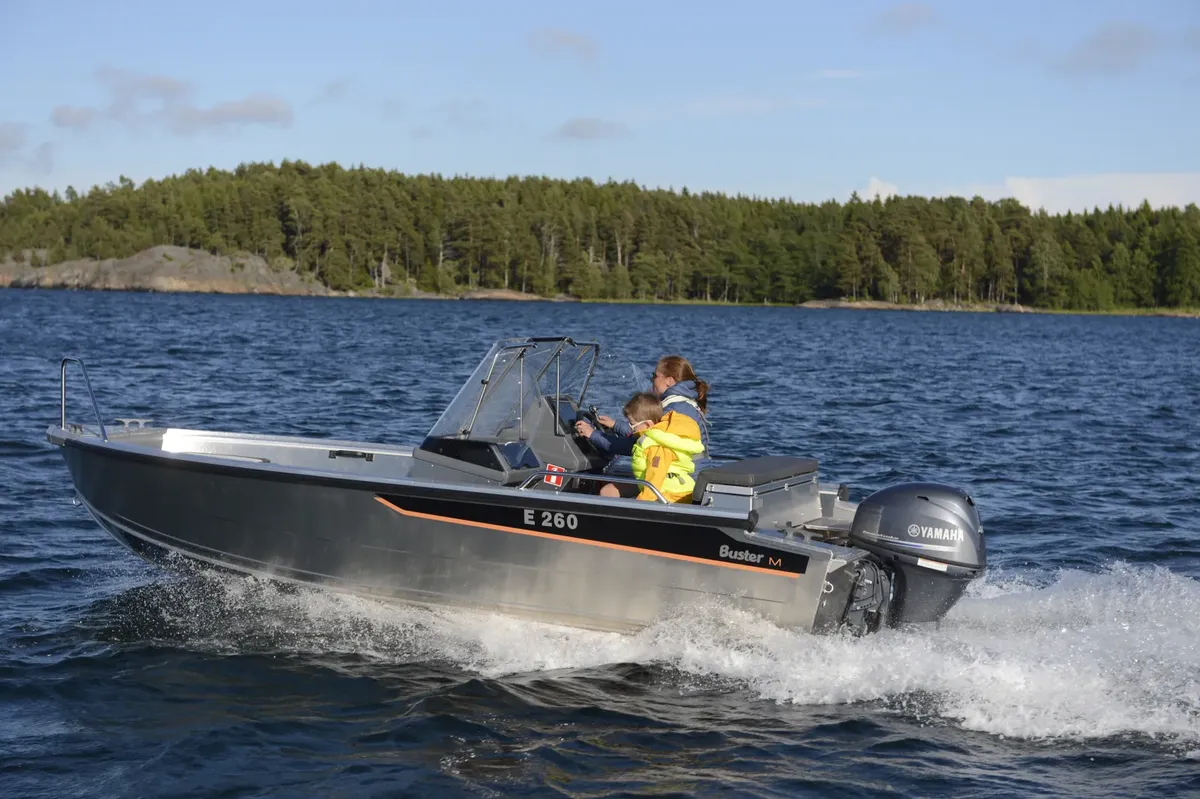 Buster M2: Boat cruising with passengers on a lake