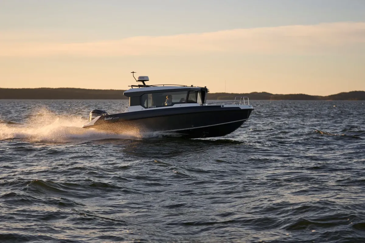 Buster Magnum Cabin: Boat cruising at sunset