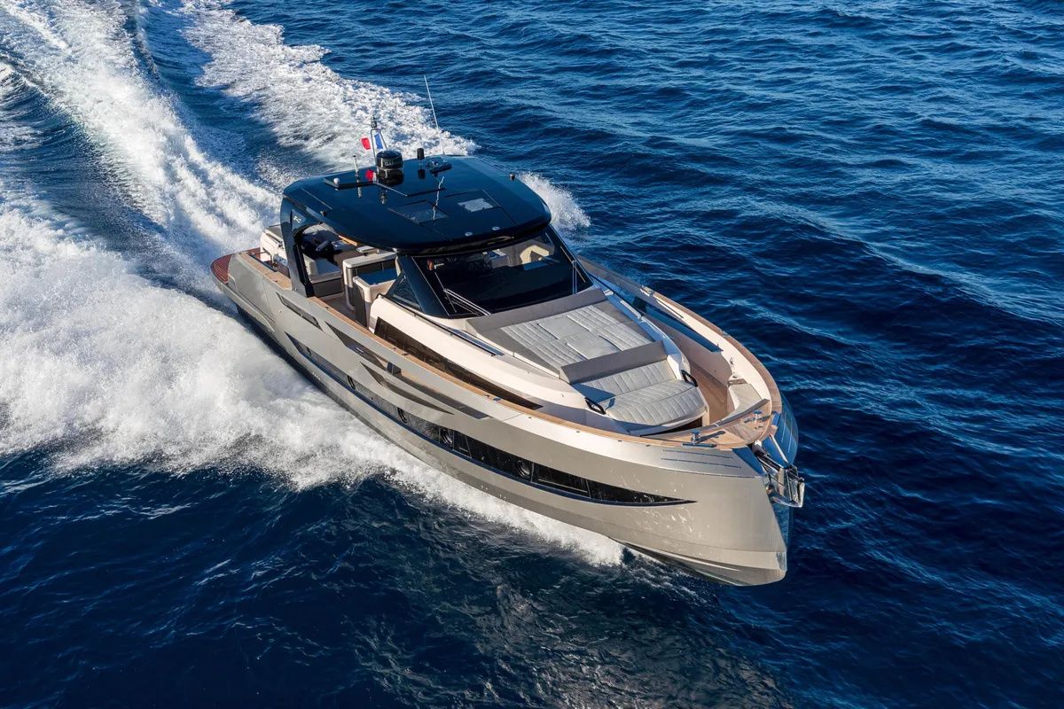 Cayman Yachts 540WA: Ein Boot, das auf dem Meer fährt und eine Heckwelle hinter sich herzieht