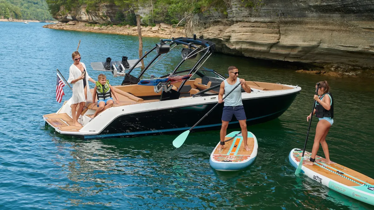 Cobalt Boats CS23: Boat with a family and stand-up paddleboarders