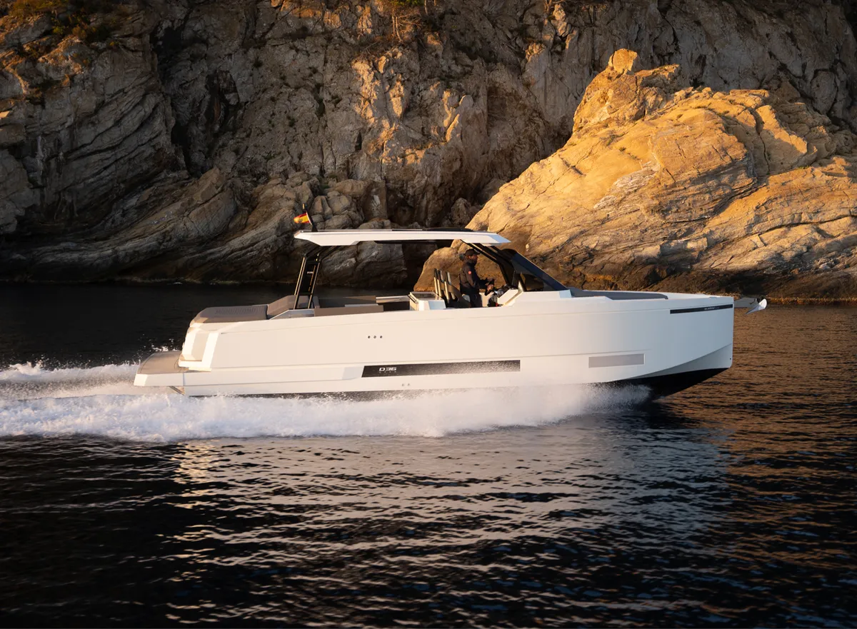De Antonio Yachts D36 Open: Boat cruising past rocks