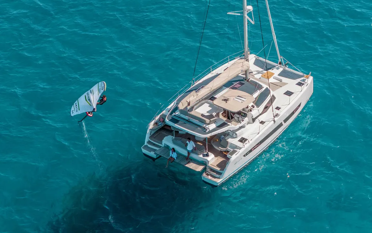 Fountaine Pajot FP44: Catamaran with a windsurfer at sea