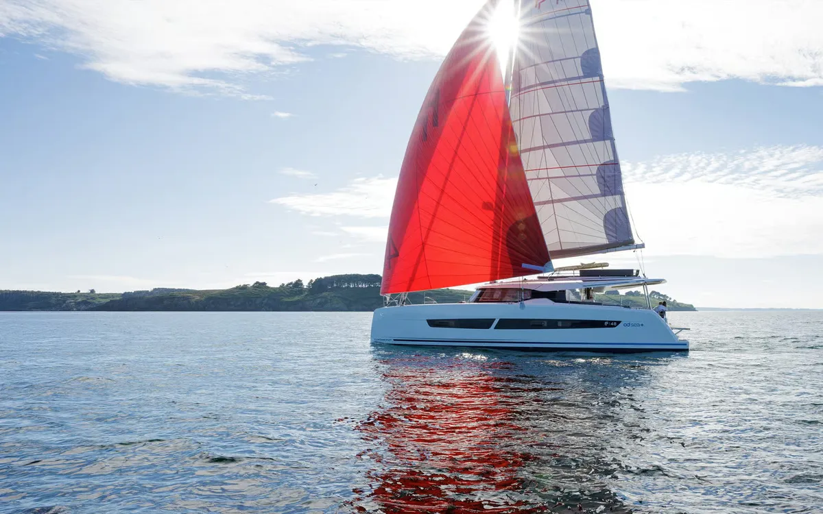 Fountaine Pajot FP48: Catamaran sailing with a red spinnaker