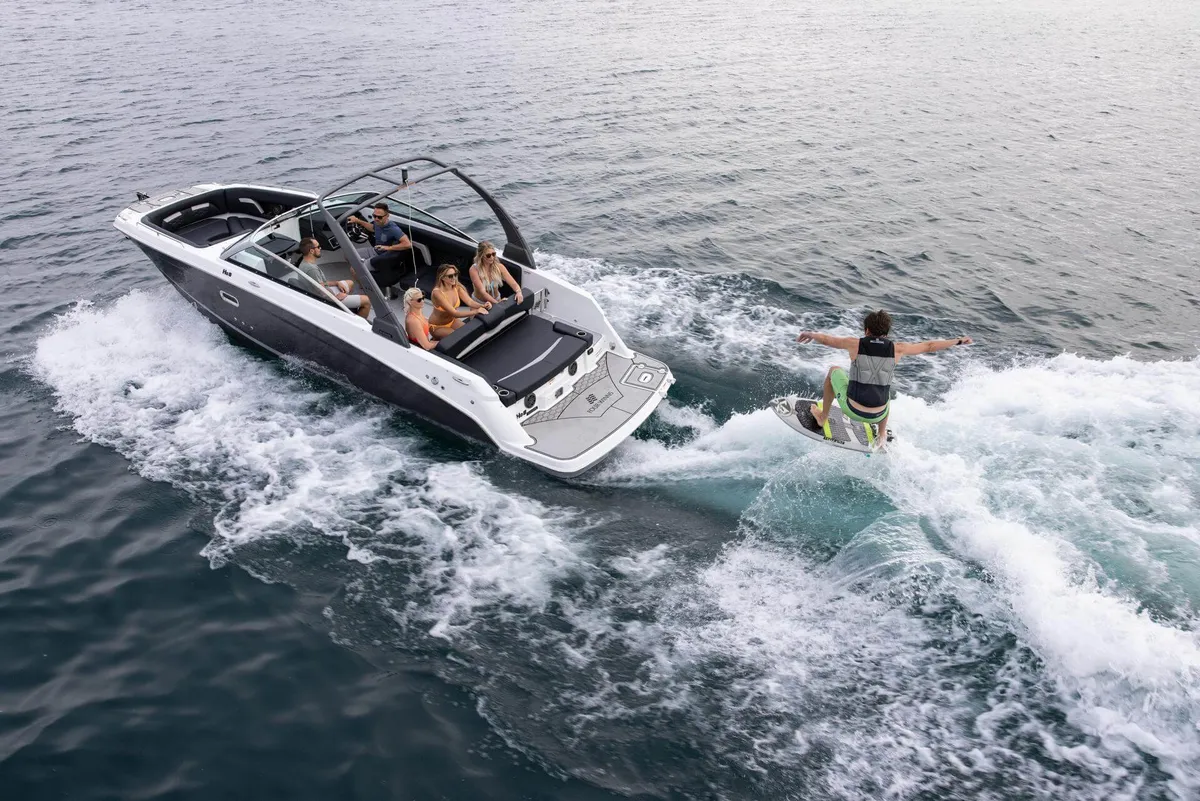 Four Winns HD8 Surf: Boat with a wakesurfer on the water