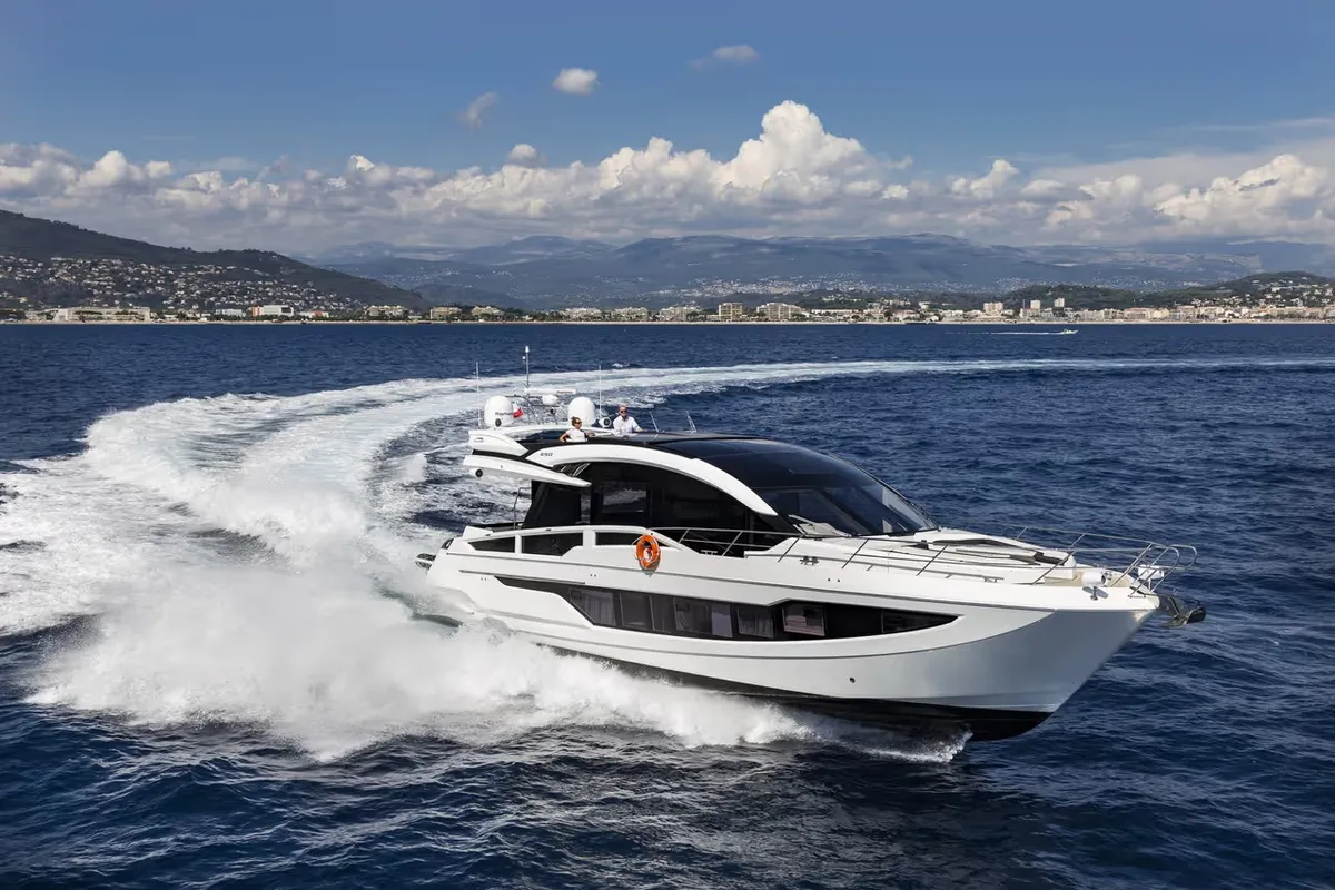 Galeon Yachts 650 SKY: White boat cruising at sea