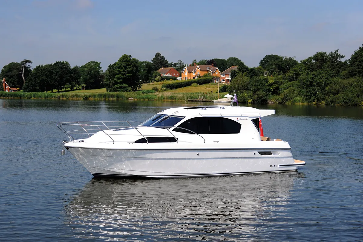 Haines Marine 32 Sedan: White motorboat cruising on a river