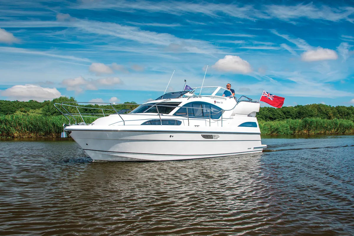 Haines Marine 320: White boat cruising on a river