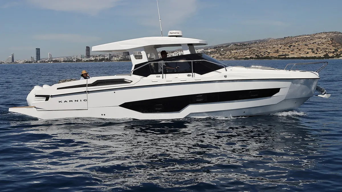 Karnic Boats CS10-HT: A white motorboat cruising at sea