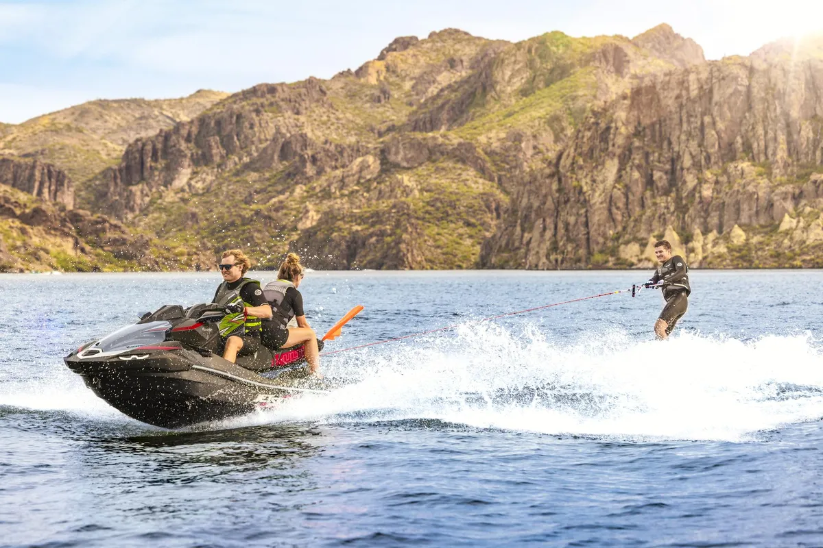 Kawasaki Jet Ski Ultra 160LX-S: A jet ski pulls a water skier across a lake