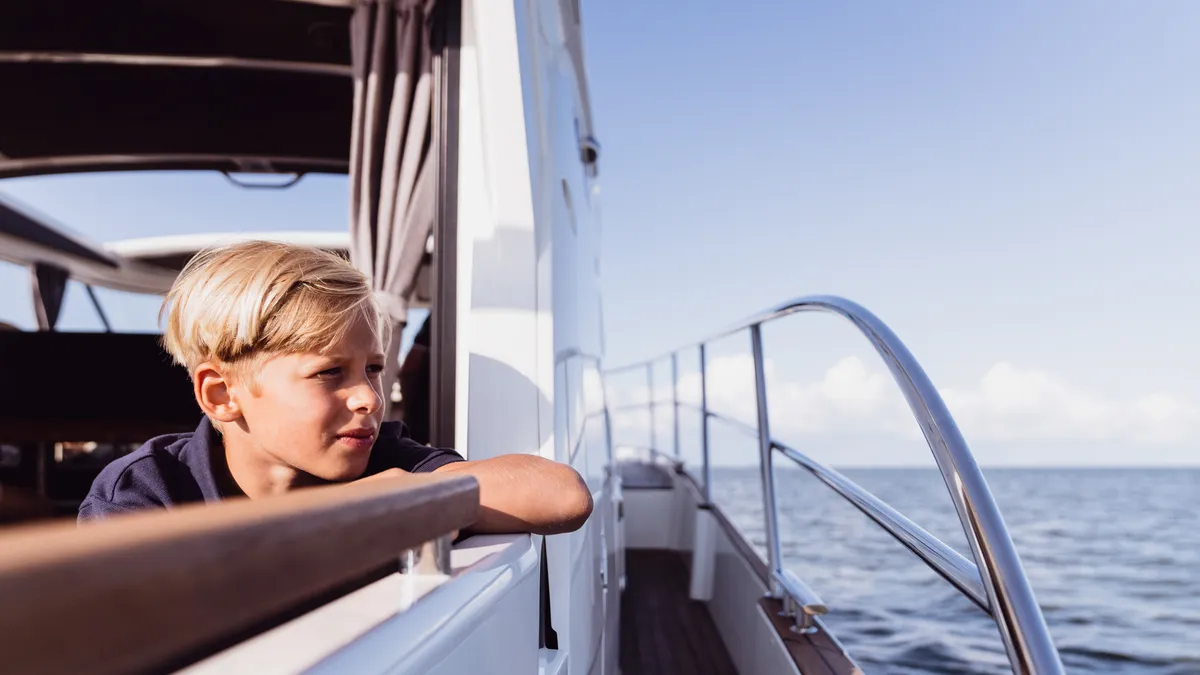 Marex 330 Scandinavia: Boy looking over the railing at the sea