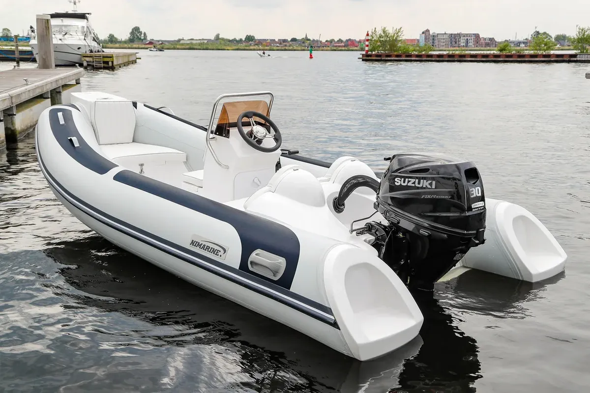 Nimarine MX 410 RIB: Rubber dinghy moored to a jetty