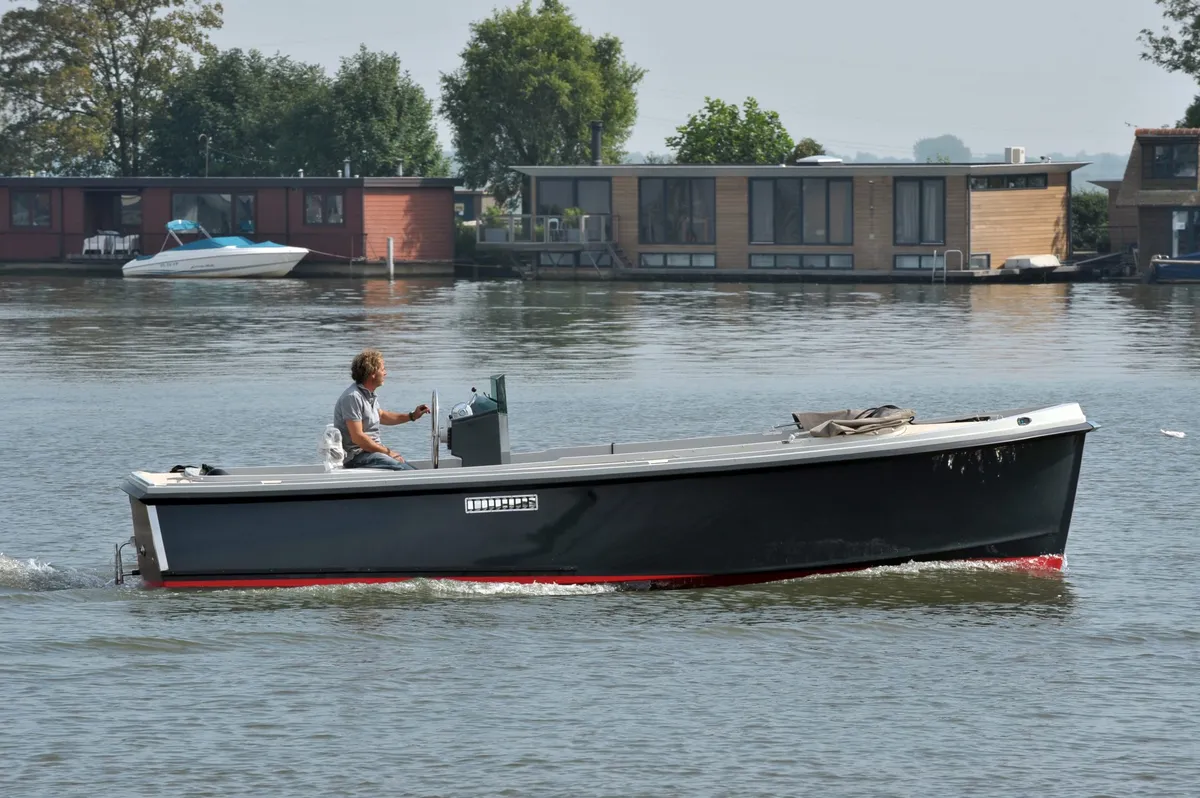 ONJ Motorboten Tender 720: Un bateau à moteur noir filant sur l'eau