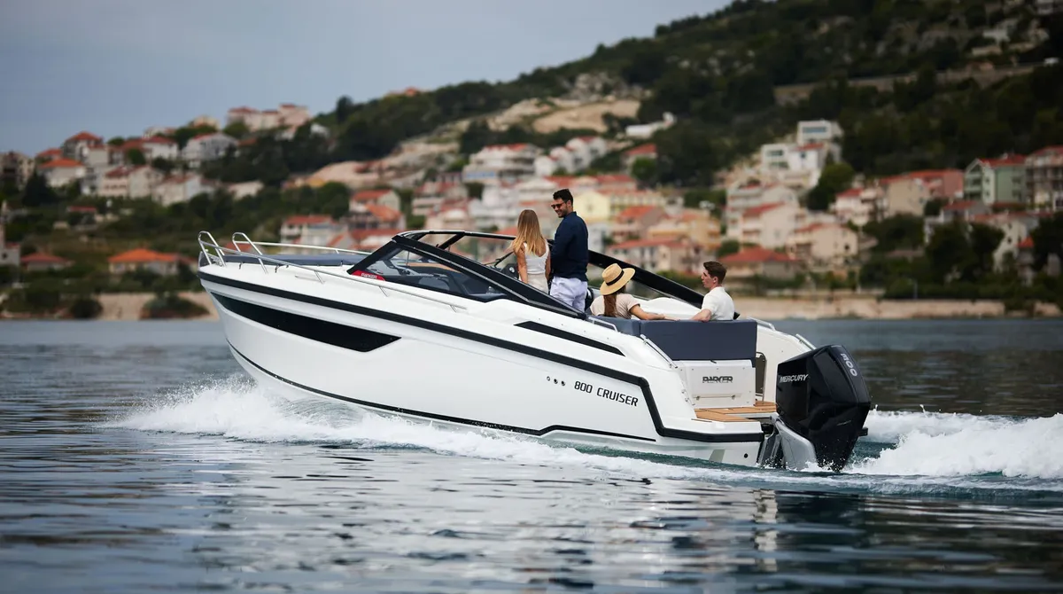 Parker Poland 800 Cruiser: Boat cruising off a coastal village