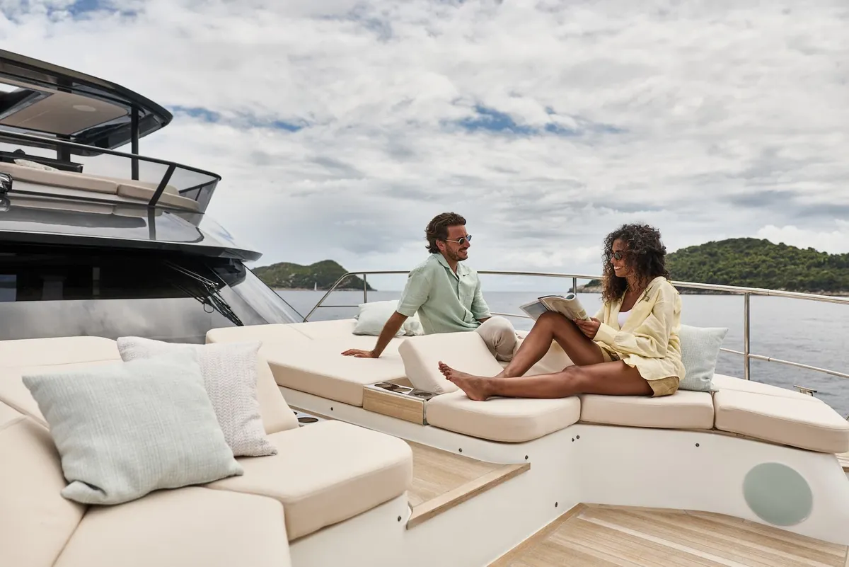 Prestige Yachts M7: Couple relaxing on the sun deck
