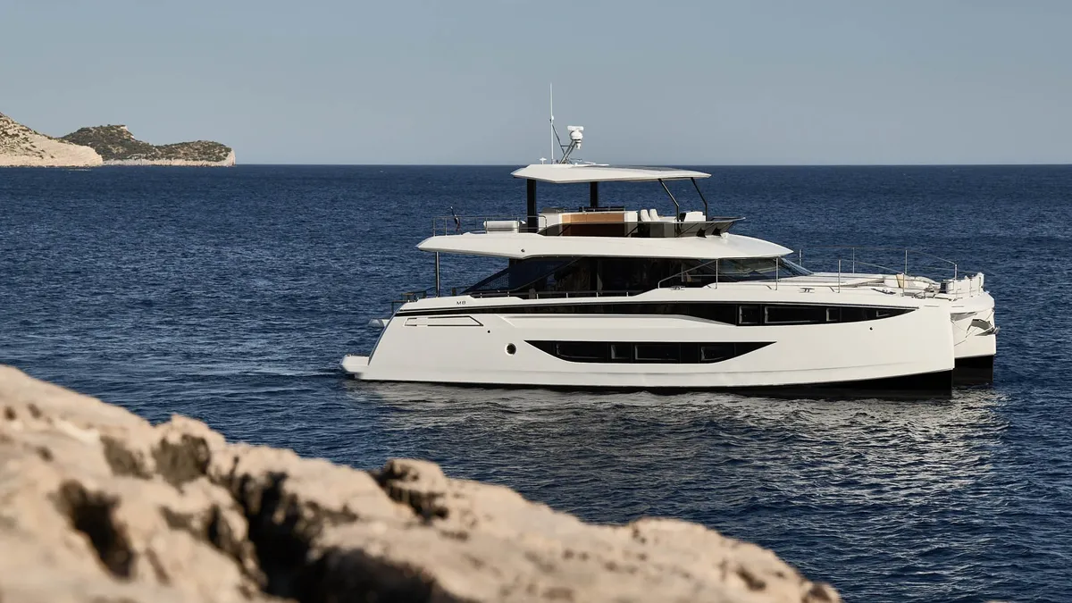 Prestige Yachts M8 EVO: White catamaran cruising along the coastline
