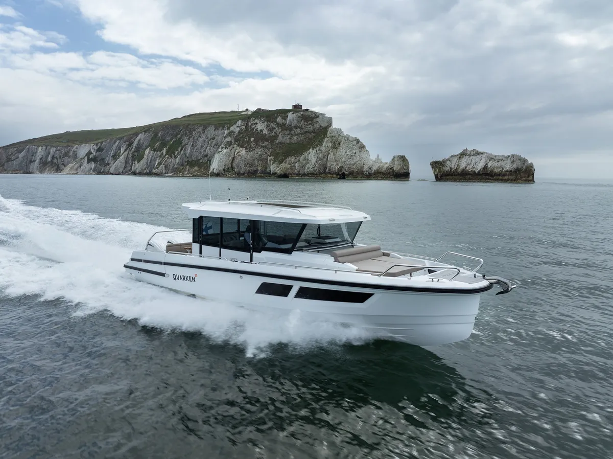 Quarken Boats 35 Cabin Tourer: Boat cruising past cliffs