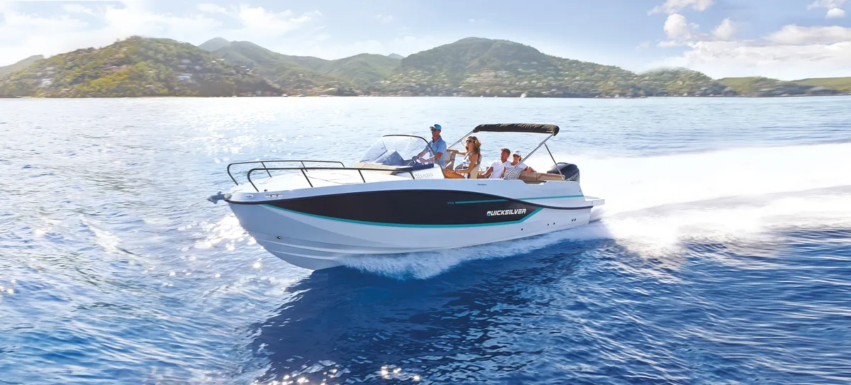 Quicksilver 755 Sundeck: Boat cruising at sea with mountains in the background