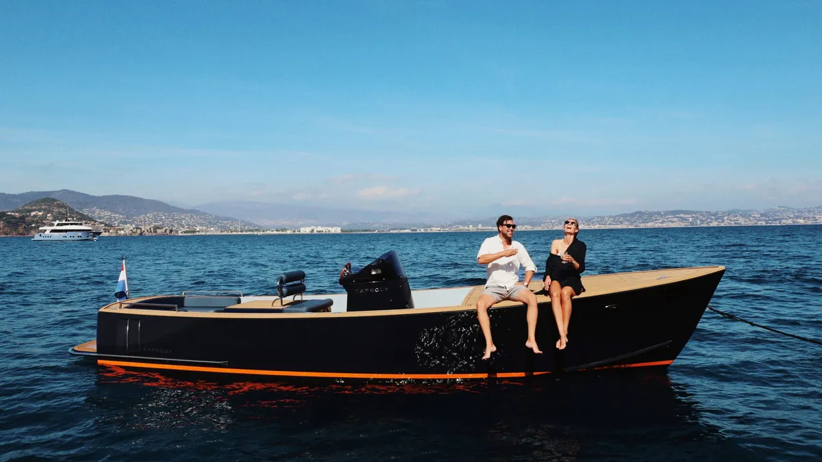 Rapsody Yachts Tender: Couple sitting on a boat