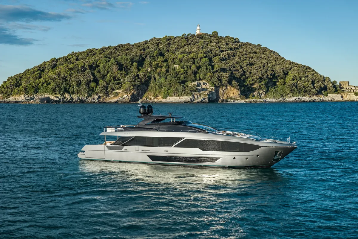 Riva 112' Dolcevita Super New: Yacht cruising past a green island