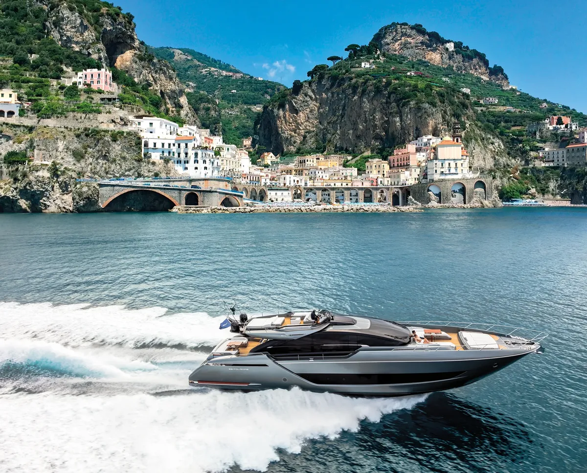 Riva 88' Folgore: Boat cruising off a coastal village