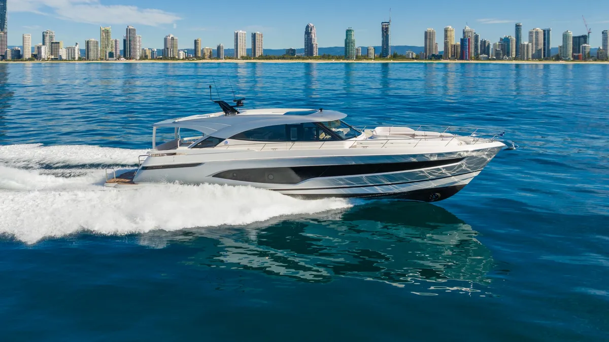 Riviera 6800 Sport Yacht Platinum Edition: Side view of a boat cruising against the skyline