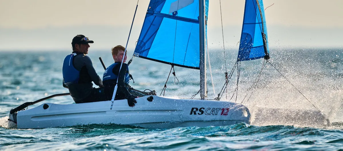 RS Sailing CAT12: Catamaran with blue sails under way