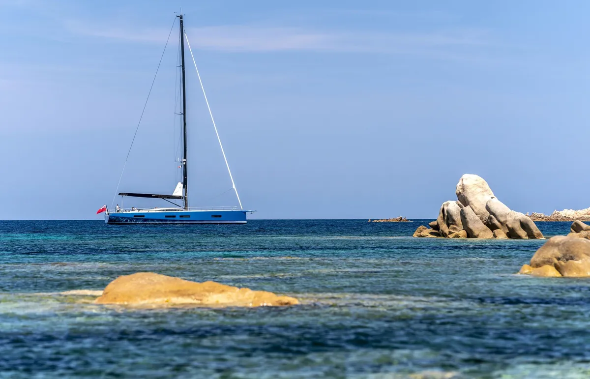Solaris Yachts 74RS: Sailing boat at anchor near rocks