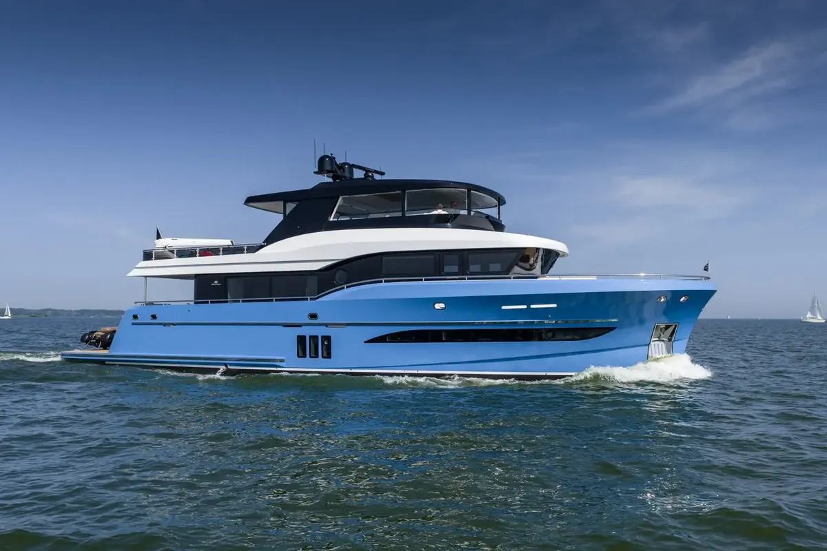 Steeler Yachts Ocean Explorer 85: Blue motor yacht cruising at sea