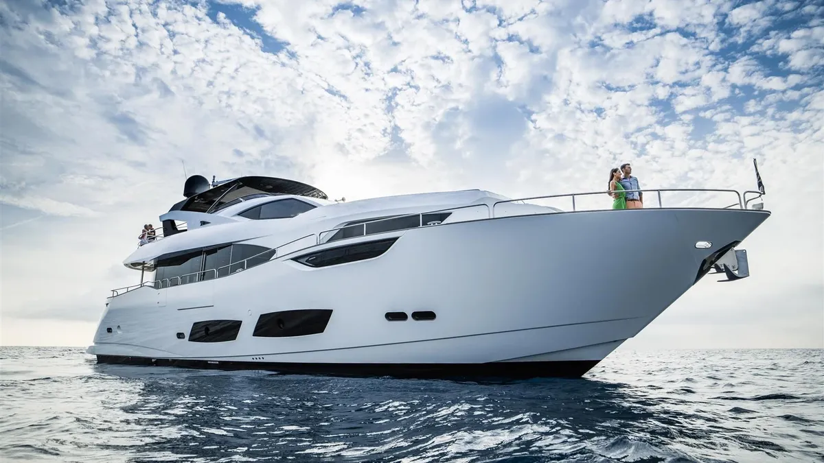 Sunseeker 95 Yacht: White yacht at sea with a couple
