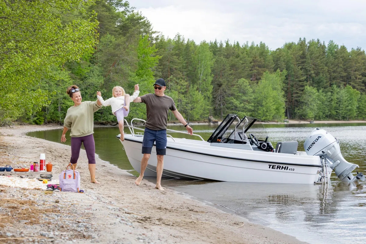 Terhi 450 TC: Family by a boat on the beach