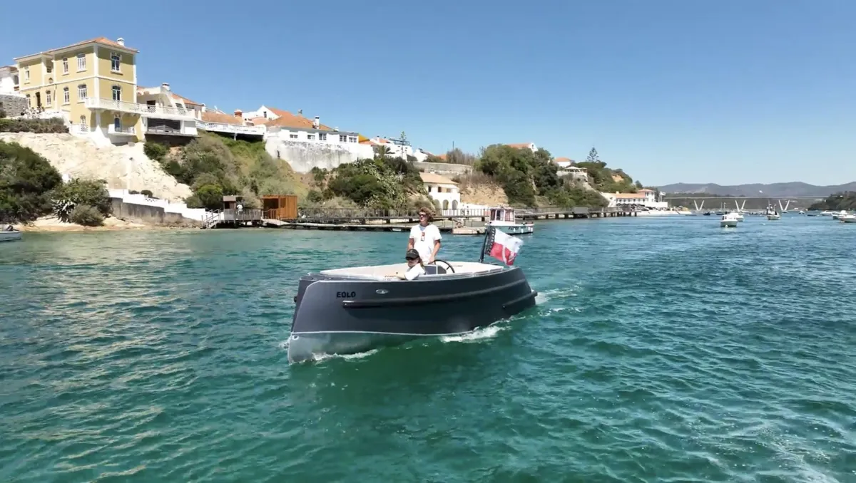 Van Vossen SportR 700: Boat cruising near a coastal village