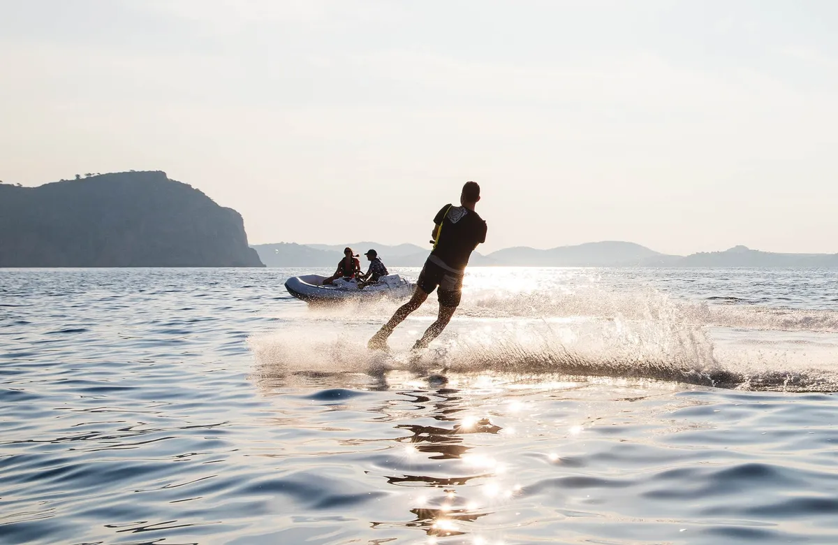 Williams Jet Tenders TurboJet 285LP: Man waterskiing behind a rubber dinghy