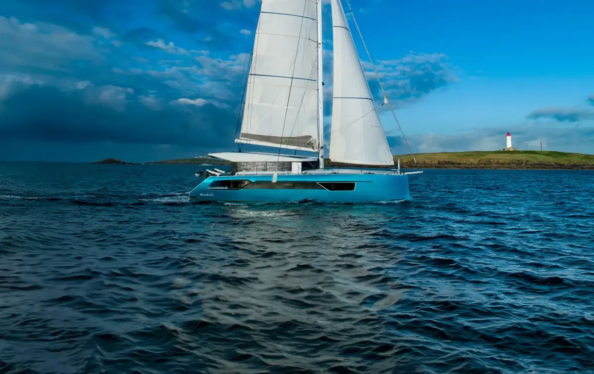 Windelo 50: Sailing boat sailing near a lighthouse