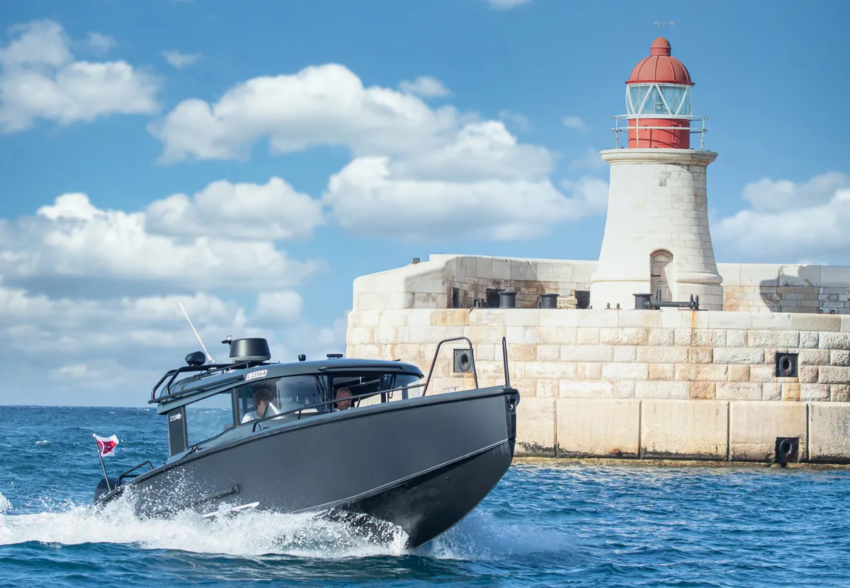 XO Boats EXPLR 10 Sport+: Boat cruising past a lighthouse