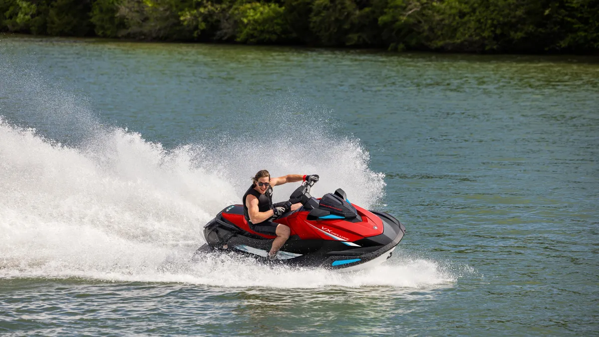 Yamaha WaveRunner VX DeLuxe: A jet ski riding through the water, creating a spray
